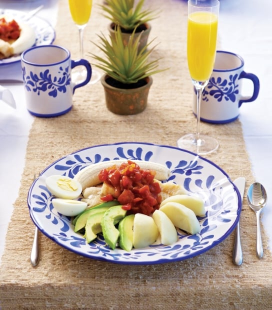 A traditional codfish breakfast with mimosas and colourful plate.