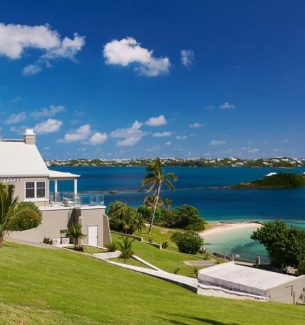 A building on a hill overlooking the water