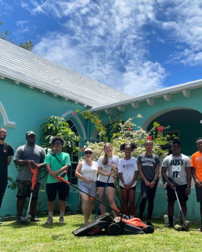 A group of people are volunteering at a Bermuda is Love event.