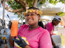 A woman is posing with lemonade at Vegan Fest